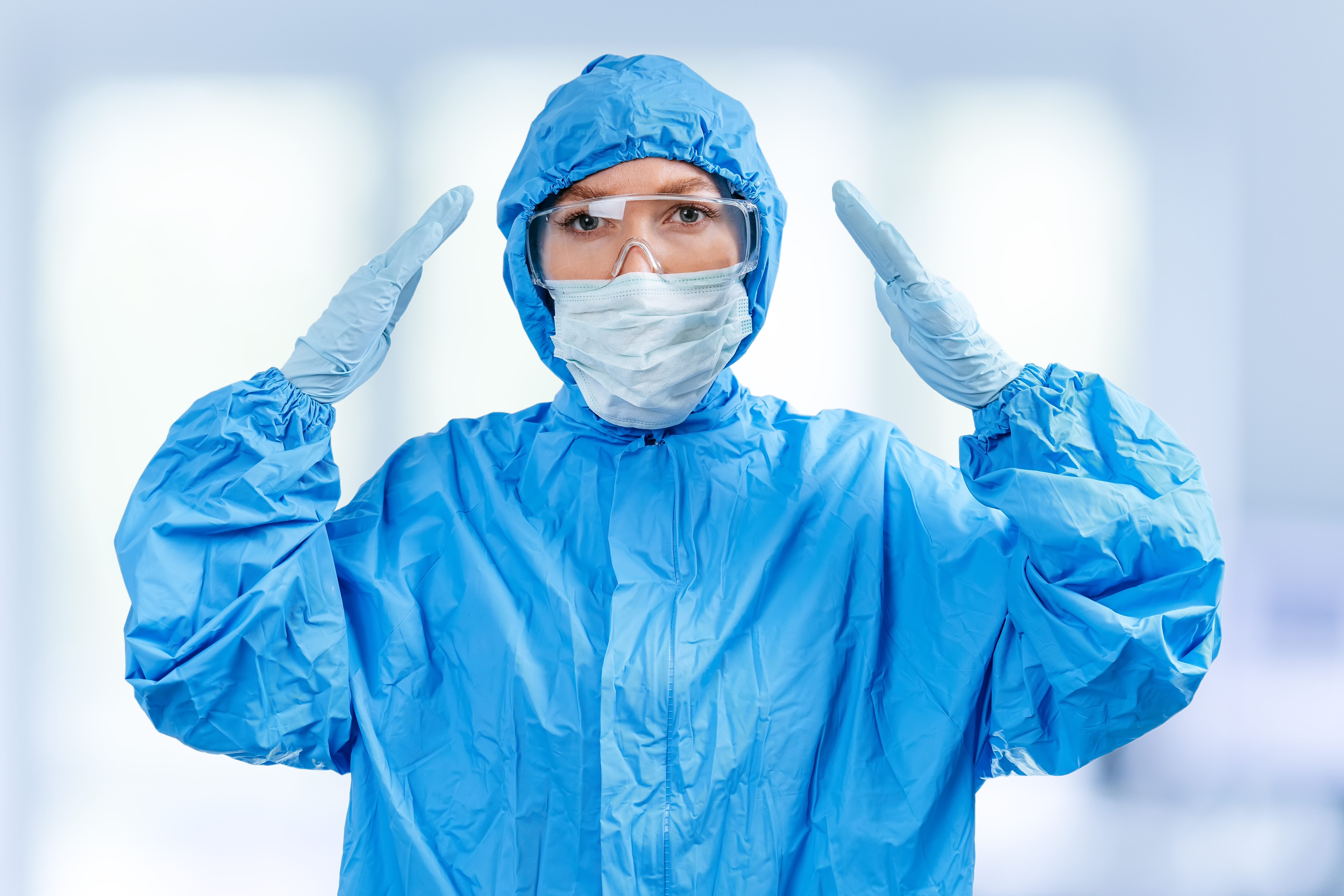 Workers in white SMS fabric cleanroom PPE suits.
