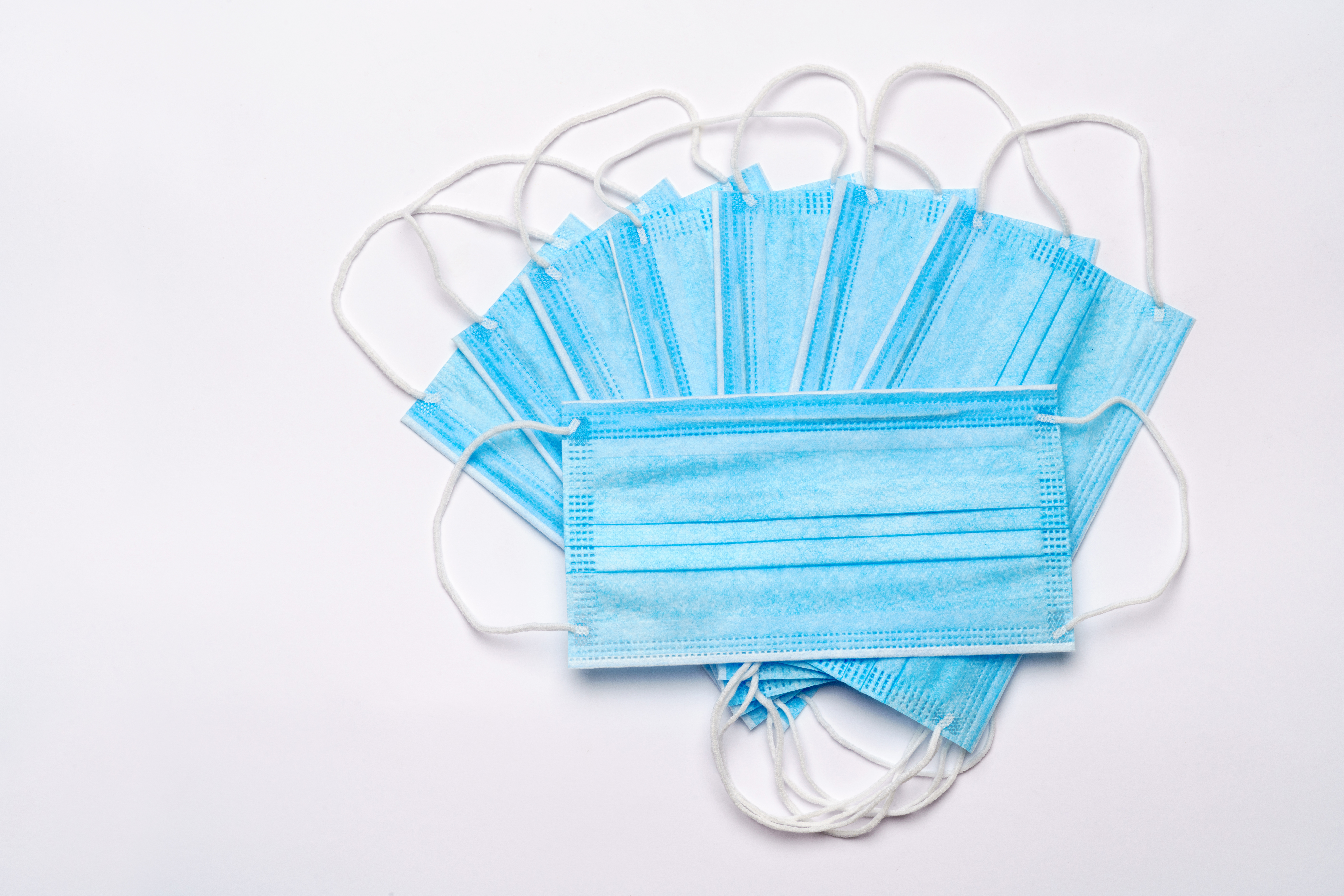 Blue surgical mask made with meltblown filter layer.